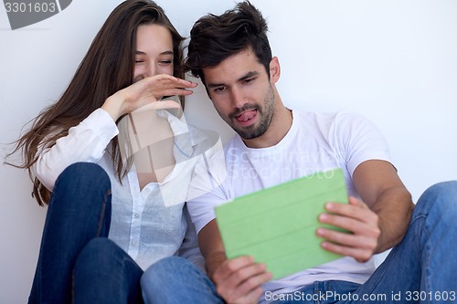 Image of couple at modern home using tablet computer