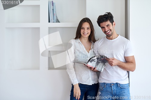 Image of relaxed young couple at home staircase