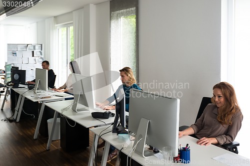 Image of Young team working at desks in stylish office