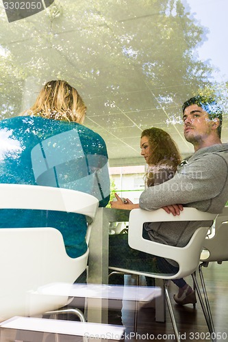 Image of Three business colleagues communicating during break