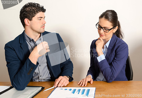 Image of two young business people discussing