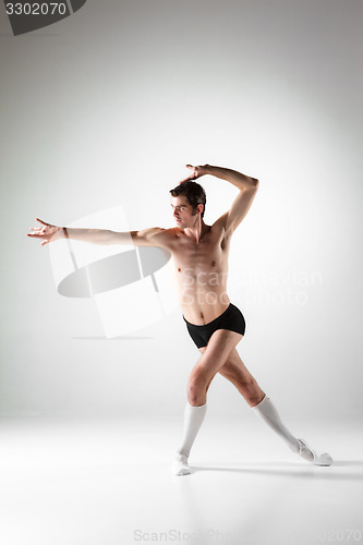 Image of The young attractive modern ballet dancer on white background