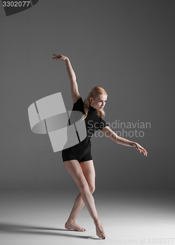 Image of Young beautiful modern style dancer posing on a studio background
