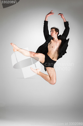 Image of The young attractive modern ballet dancer jumping on white background