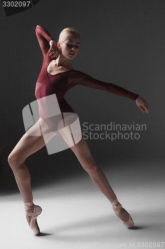 Image of Young beautiful modern style dancer posing on a studio background