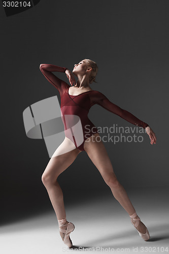 Image of Young beautiful modern style dancer posing on a studio background