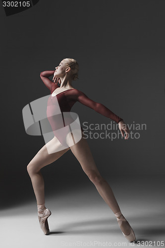 Image of Young beautiful modern style dancer posing on a studio background