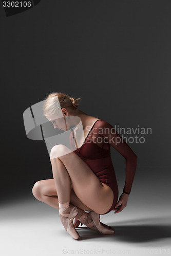 Image of Young beautiful modern style dancer posing on a studio background