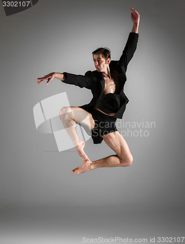 Image of The young attractive modern ballet dancer jumping on white background