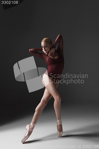 Image of Young beautiful modern style dancer posing on a studio background