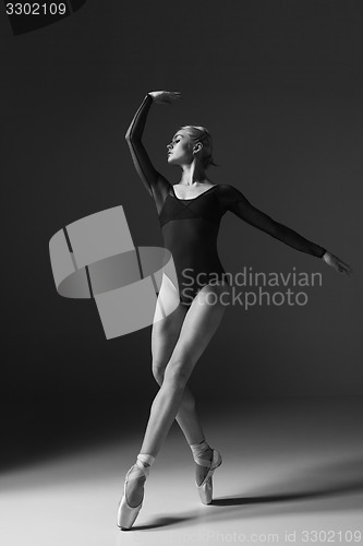 Image of Young beautiful modern style dancer posing on a studio background