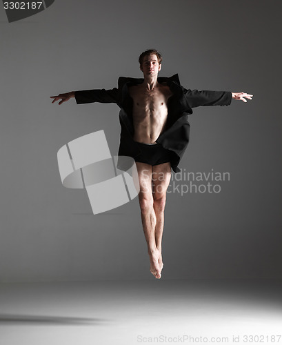 Image of The young attractive modern ballet dancer jumping on white background