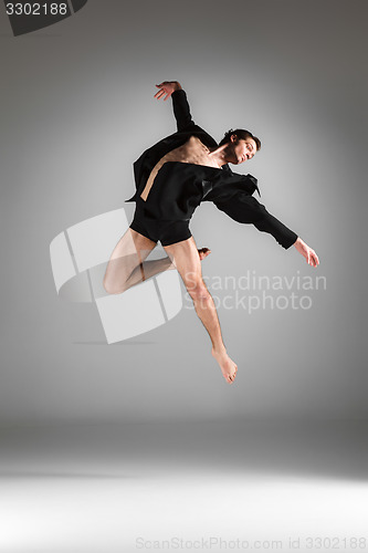 Image of The young attractive modern ballet dancer jumping on white background