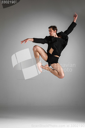 Image of The young attractive modern ballet dancer jumping on white background