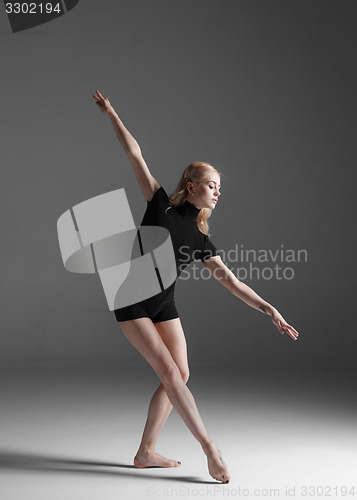 Image of Young beautiful modern style dancer posing on a studio background