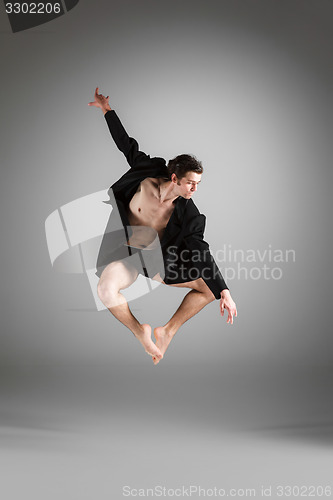 Image of The young attractive modern ballet dancer jumping on white background
