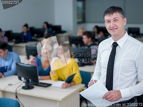 Image of students with teacher  in computer lab classrom