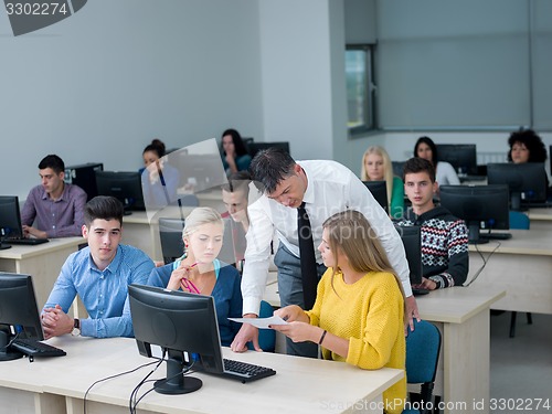 Image of students with teacher  in computer lab classrom