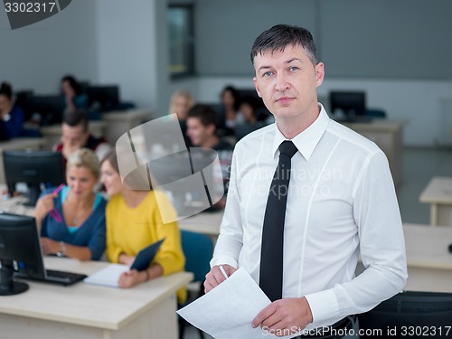 Image of students with teacher  in computer lab classrom