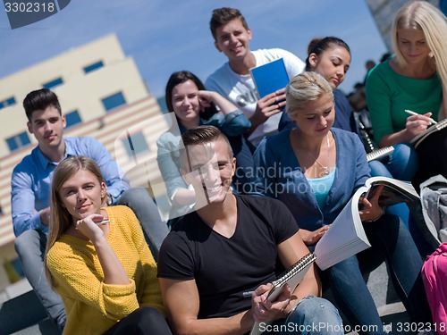 Image of students outside sitting on steps