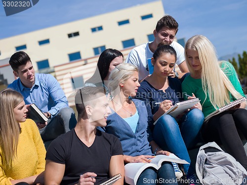 Image of students outside sitting on steps