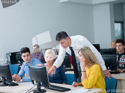 Image of students with teacher  in computer lab classrom