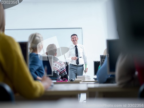 Image of students with teacher  in computer lab classrom