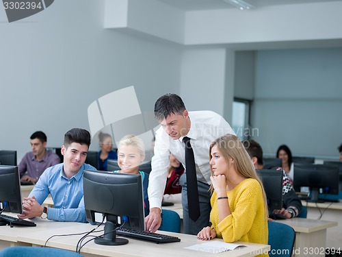 Image of students with teacher  in computer lab classrom