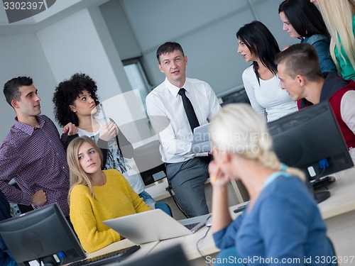 Image of students with teacher  in computer lab classrom