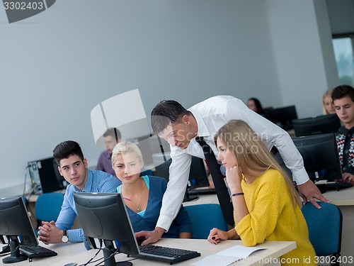 Image of students with teacher  in computer lab classrom