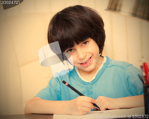 Image of child doing homework with computer, portrait