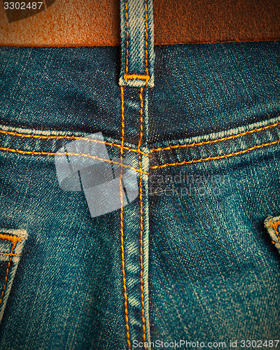 Image of ol blue denim with seams and leather belt 