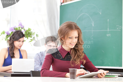 Image of smiling young girl with tablet