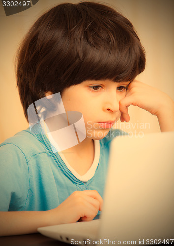 Image of child looking at a computer monitor