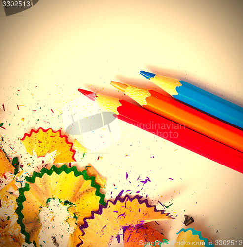 Image of three colored pencils and shavings