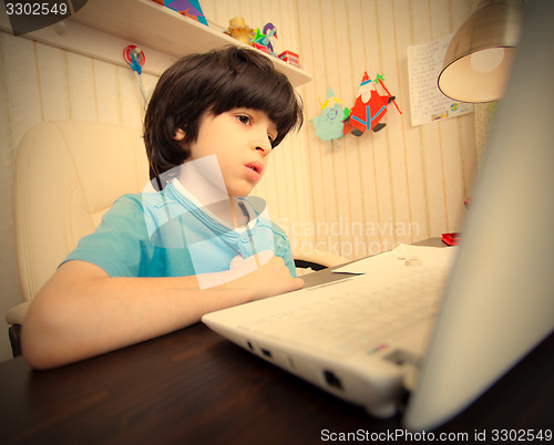 Image of child with computer, distance learning