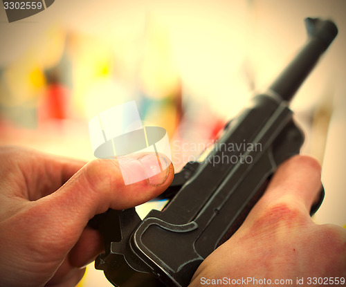 Image of Luger automatic pistol in a human hands