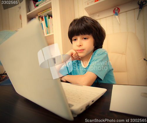 Image of boy with computer, distance learning