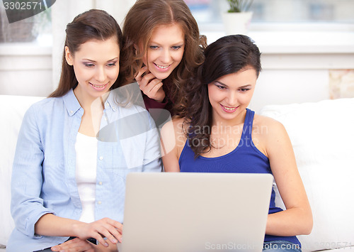 Image of Three students and a notebook