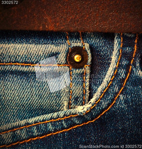 Image of jeans with a brown leather belt