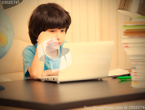 Image of boy looking at a computer monitor