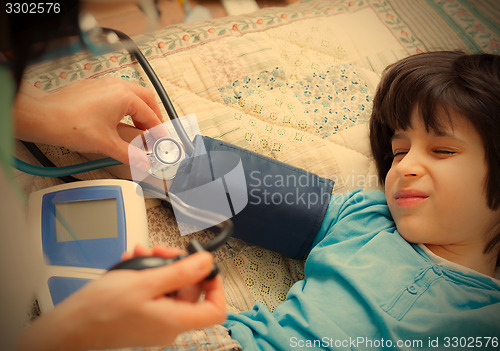 Image of Doctor pediatrician measure blood pressure