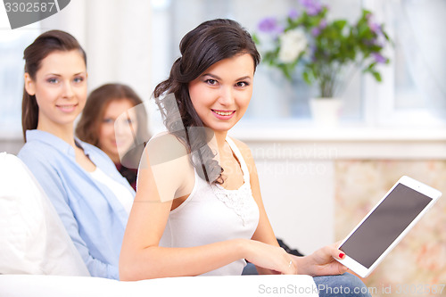 Image of smiling young girl with tablet