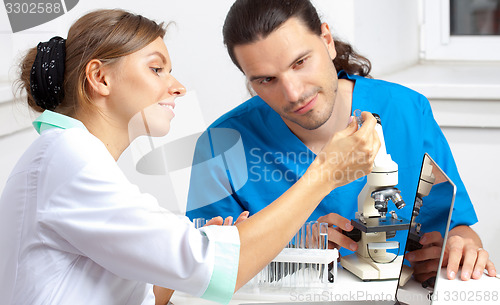 Image of scientist shows test tube