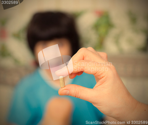 Image of hand of a doctor with pill