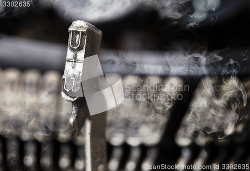 Image of U hammer - old manual typewriter - mystery smoke