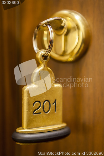 Image of Hotel Room Key lying on Bed with keyring