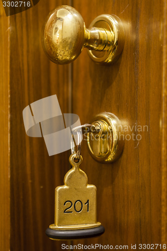 Image of Hotel Room Key lying on Bed with keyring