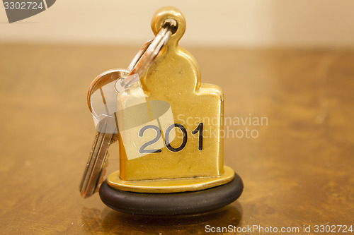 Image of Hotel Room Key lying on Bed with keyring