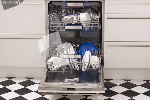 Image of Dishwasher loades in a kitchen with clean dishes